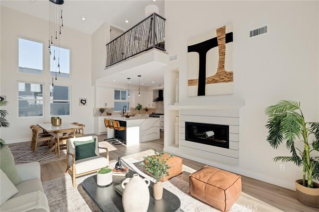 1802 Blossom Ln, Redondo Beach, CA 90278 - living room with a high ceiling and light wood-style floors
