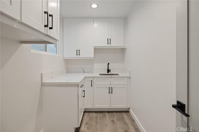 1802 Blossom Ln, Redondo Beach, CA 90278 - kitchen with light wood finished floors, white cabinetry, recessed lighting, and light stone counters