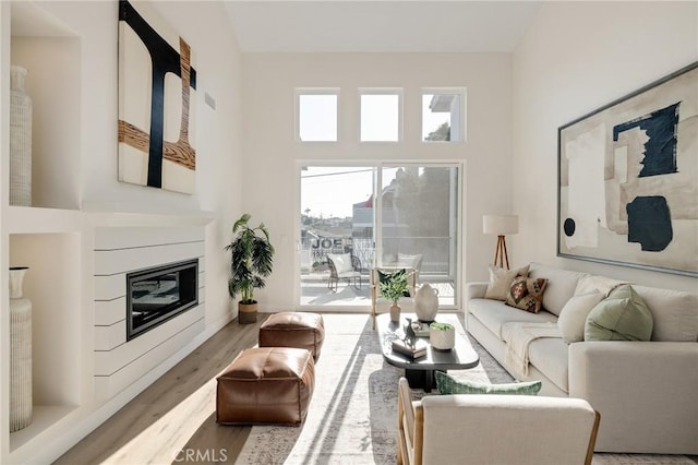 1802 Blossom Ln, Redondo Beach, CA 90278 - living room with wood finished floors, a glass covered fireplace, and a towering ceiling