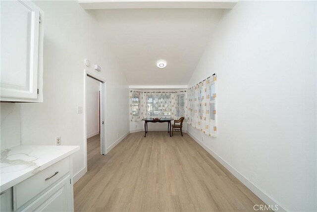 15251 Cedarwood Ave, Midway City, CA 92655 - corridor with light wood-style floors, lofted ceiling, and baseboards
