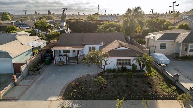 15251 Cedarwood Ave, Midway City, CA 92655 - view of front of home with covered porch, concrete driveway, a residential view, and roof with shingles