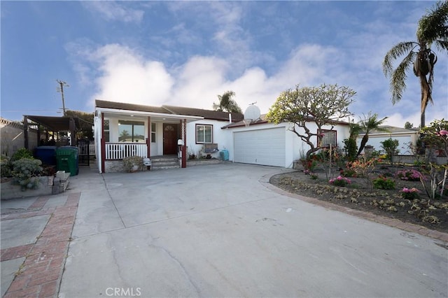 15251 Cedarwood Ave, Midway City, CA 92655 - view of front of house featuring covered porch, an attached garage, stucco siding, and driveway