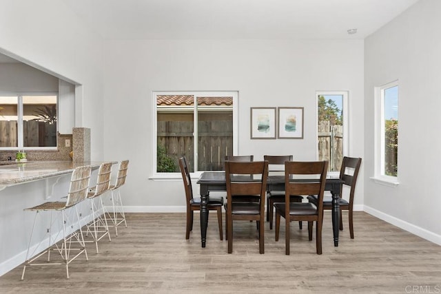 2345 Levante St, Carlsbad, CA 92009 - dining room with light wood-type flooring, plenty of natural light, and baseboards