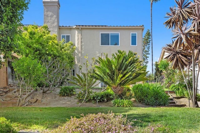 2345 Levante St, Carlsbad, CA 92009 - view of property exterior with a chimney, stucco siding, and a tile roof