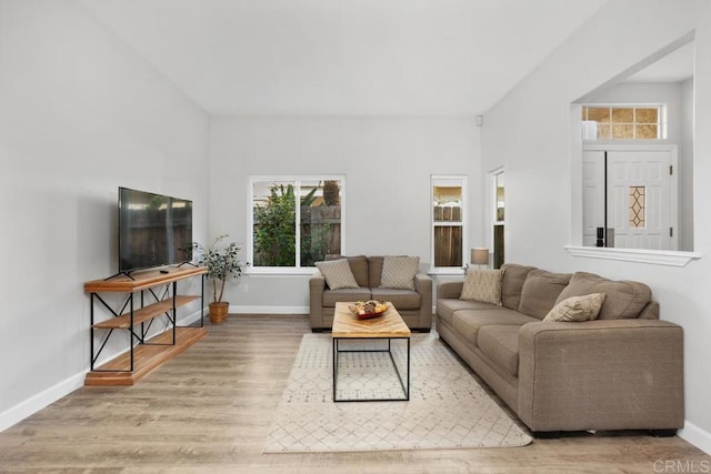 2345 Levante St, Carlsbad, CA 92009 - living room with plenty of natural light, wood finished floors, and baseboards