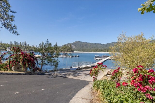 37731 Shoreline Dr, Bass Lake, CA 93604 - water view featuring a boat ramp, a dock, and mountains