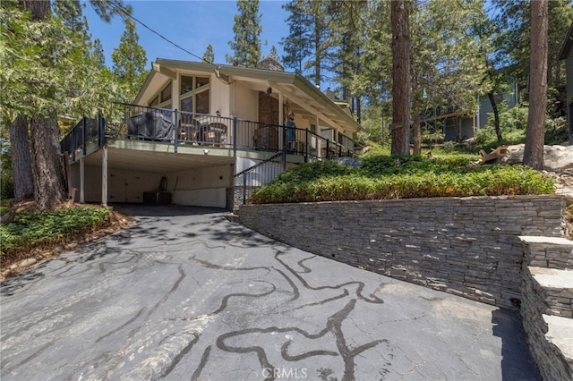 37731 Shoreline Dr, Bass Lake, CA 93604 - view of front facade featuring asphalt driveway, a carport, stairs, and central AC
