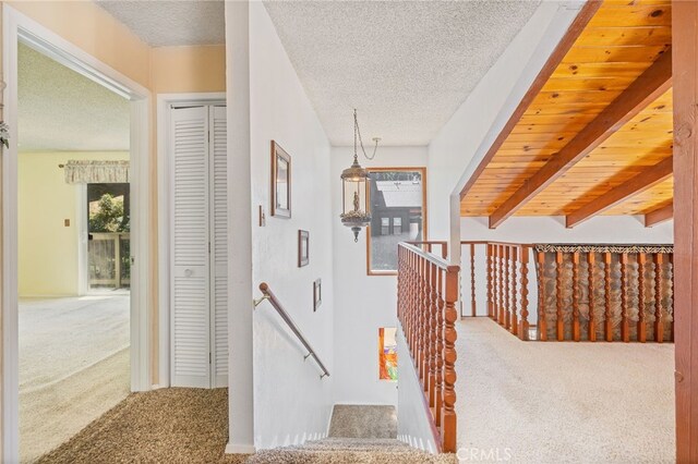 37731 Shoreline Dr, Bass Lake, CA 93604 - hallway featuring carpet, a textured ceiling, and an upstairs landing