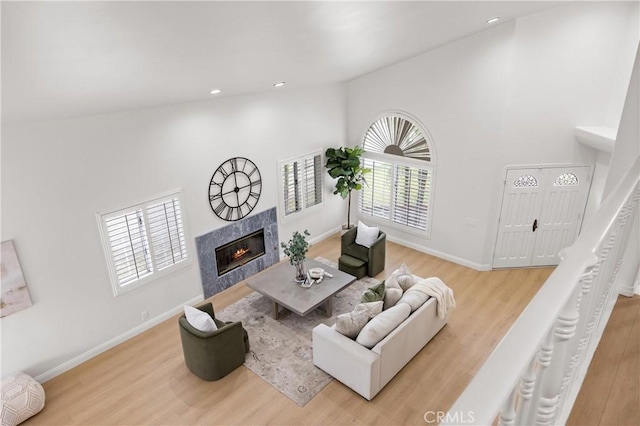 8426 Orange St, Downey, CA 90242 - living room featuring healthy amount of natural light, a fireplace, wood finished floors, and high vaulted ceiling