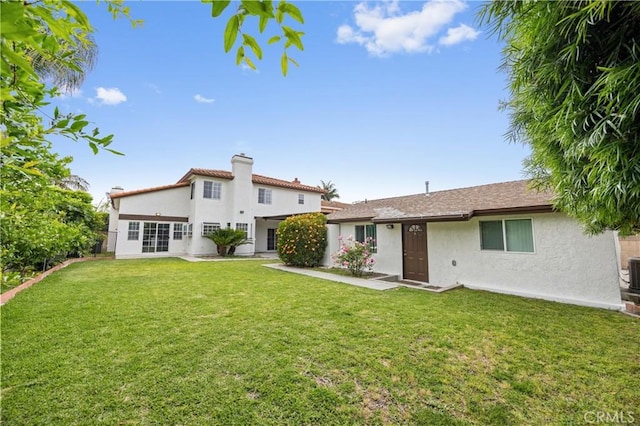 8426 Orange St, Downey, CA 90242 - rear view of property with stucco siding, a yard, and a chimney