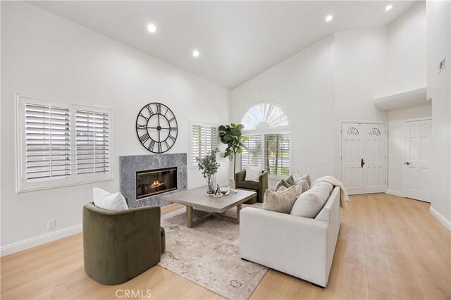 8426 Orange St, Downey, CA 90242 - living area with high vaulted ceiling, a premium fireplace, light wood-style flooring, and recessed lighting