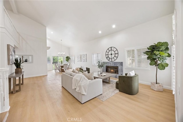 8426 Orange St, Downey, CA 90242 - living area featuring a premium fireplace, light wood-type flooring, recessed lighting, high vaulted ceiling, and a chandelier