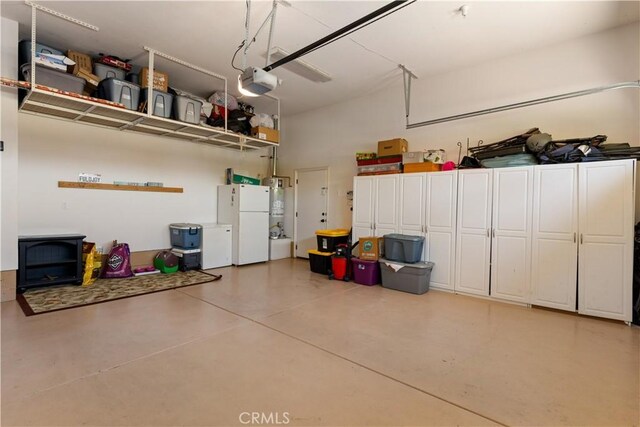 283 Katie Ct, Lakeport, CA 95453 - garage featuring freestanding refrigerator, a garage door opener, and strapped water heater
