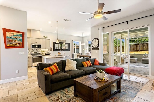 283 Katie Ct, Lakeport, CA 95453 - living room featuring ceiling fan, stone tile flooring, baseboards, and recessed lighting