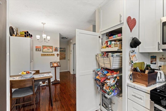 10214 Michala Pl, Santee, CA 92071 - kitchen with dark wood-style floors, light countertops, a chandelier, freestanding refrigerator, and white cabinetry