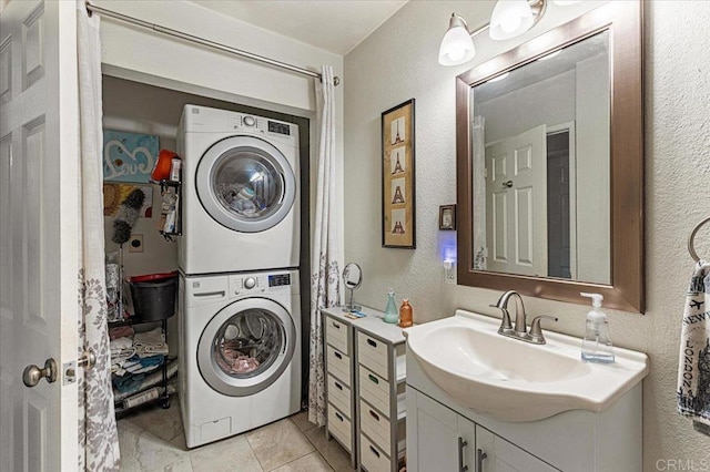 10214 Michala Pl, Santee, CA 92071 - bathroom featuring estacked washer and dryer, a textured wall, vanity, and tile patterned flooring