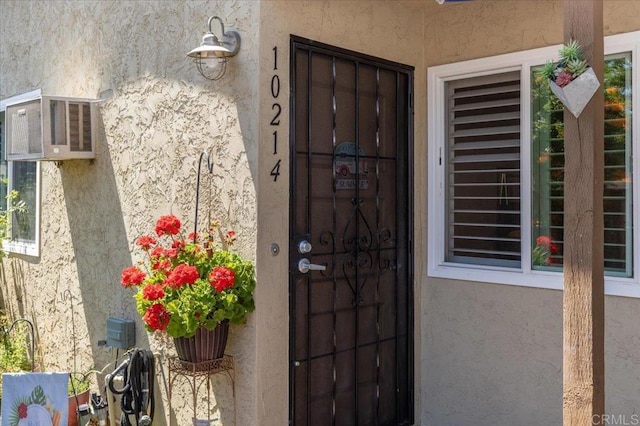 10214 Michala Pl, Santee, CA 92071 - property entrance featuring stucco siding and a wall unit AC