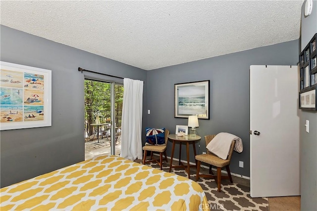 966 Willow Creek Rd Unit 36, Lake Arrowhead, CA 92352 - bedroom featuring access to outside, a textured ceiling, and baseboards