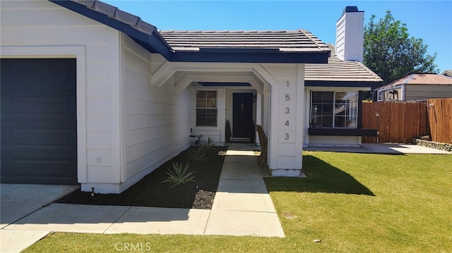 15343 Oakham Ct, Moreno Valley, CA 92551 - entrance to property with a garage, a chimney, and a tiled roof