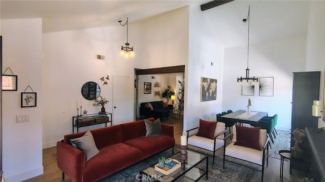 15343 Oakham Ct, Moreno Valley, CA 92551 - living room with a chandelier, high vaulted ceiling, wood finished floors, and baseboards