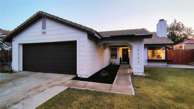 15343 Oakham Ct, Moreno Valley, CA 92551 - ranch-style home featuring a garage, a chimney, a tiled roof, and driveway