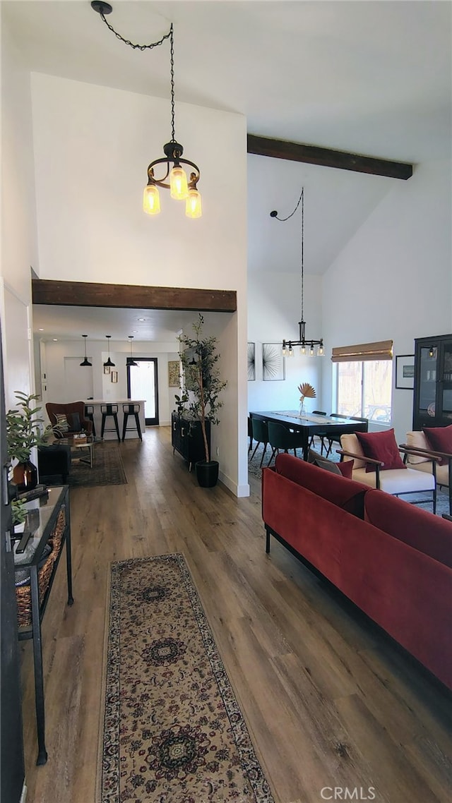 15343 Oakham Ct, Moreno Valley, CA 92551 - living area featuring high vaulted ceiling, beamed ceiling, plenty of natural light, and wood finished floors