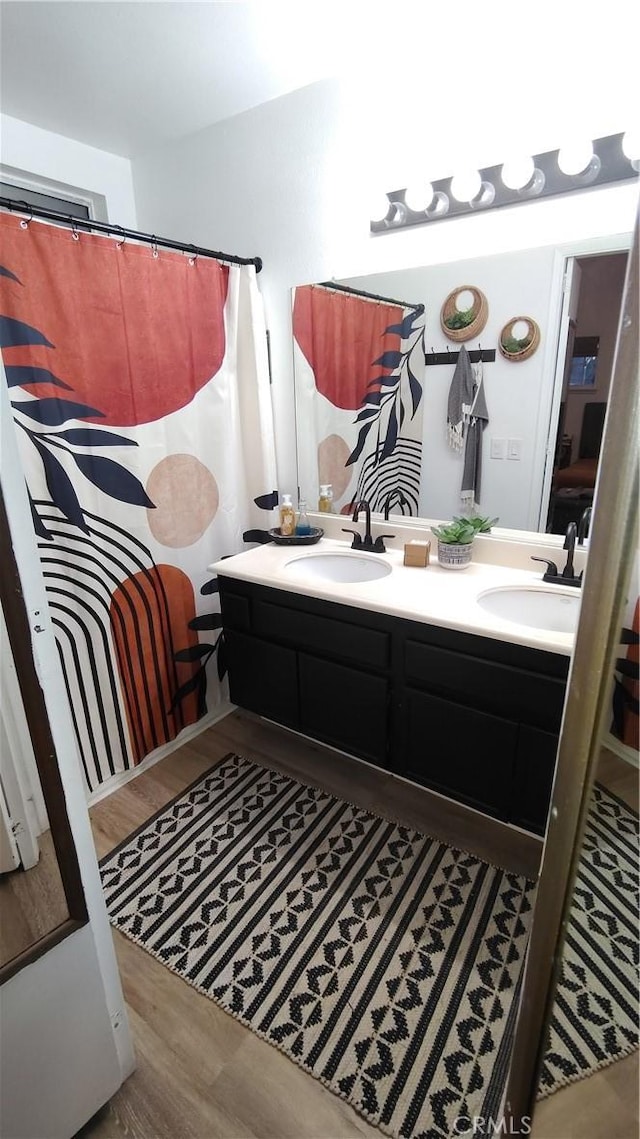 15343 Oakham Ct, Moreno Valley, CA 92551 - bathroom featuring wood finished floors and double vanity