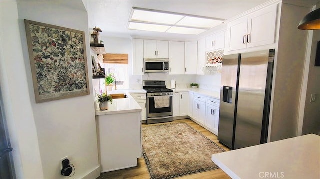 15343 Oakham Ct, Moreno Valley, CA 92551 - kitchen featuring appliances with stainless steel finishes, light wood-style floors, and white cabinetry