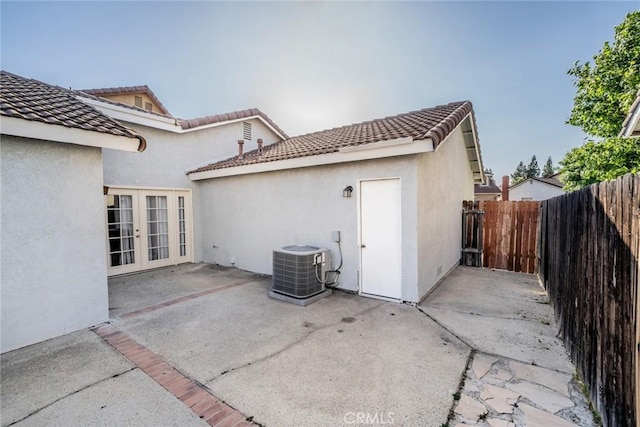 14079 El Camino Pl, Fontana, CA 92337 - back of house with french doors, a patio, stucco siding, central AC, and a tiled roof