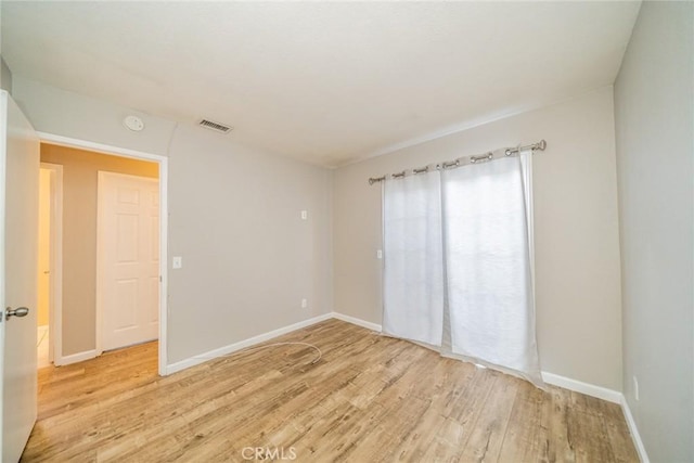 14079 El Camino Pl, Fontana, CA 92337 - spare room with light wood-style flooring, baseboards, and a smoke detector