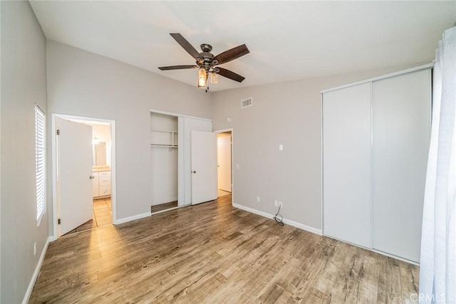 14079 El Camino Pl, Fontana, CA 92337 - unfurnished bedroom featuring two closets, wood finished floors, baseboards, and ensuite bath