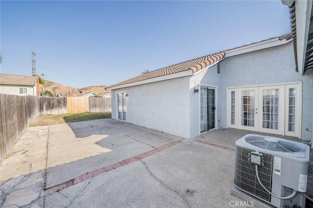 14079 El Camino Pl, Fontana, CA 92337 - fenced backyard featuring cooling unit, a patio area, and french doors