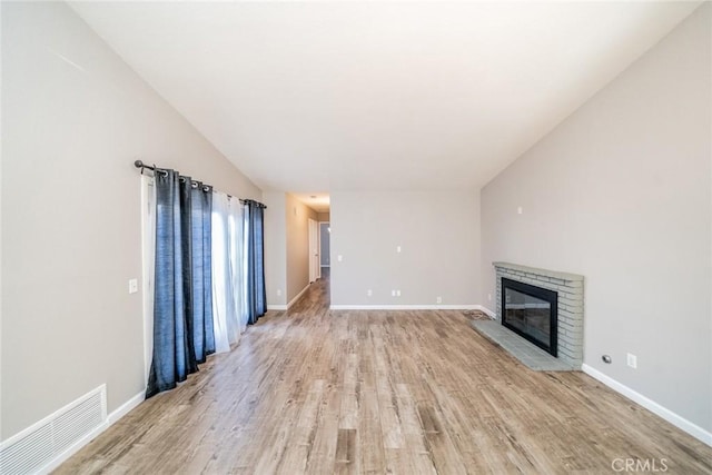 14079 El Camino Pl, Fontana, CA 92337 - unfurnished living room featuring light wood finished floors, a fireplace, and baseboards