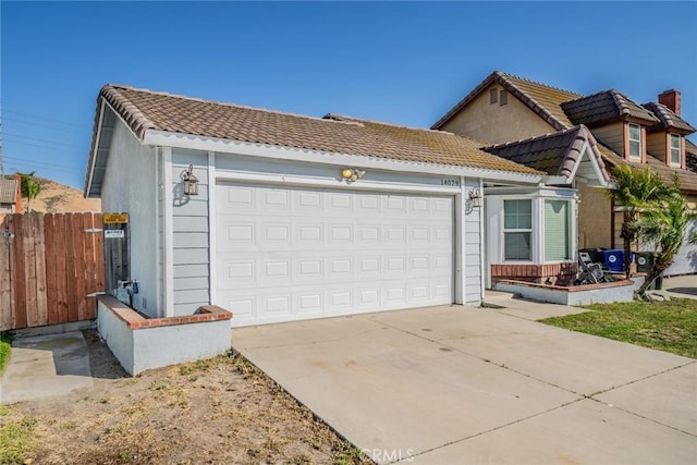 14079 El Camino Pl, Fontana, CA 92337 - view of front of house featuring an attached garage, a tile roof, concrete driveway, and stucco siding