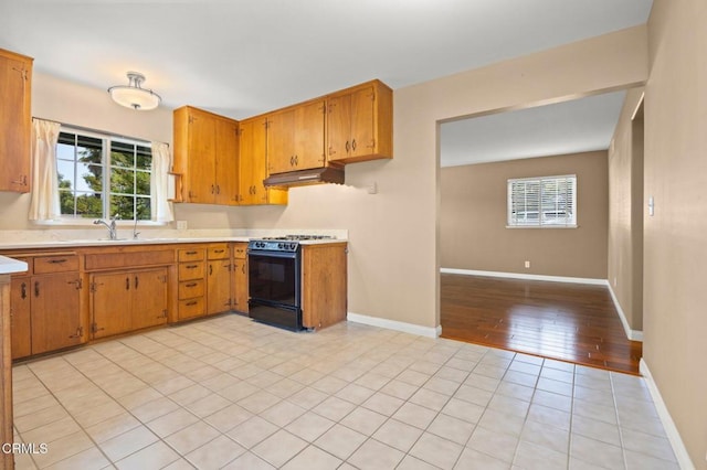 260 N Wake Forest Ave, Ventura, CA 93003 - kitchen with black gas range, under cabinet range hood, light countertops, and plenty of natural light