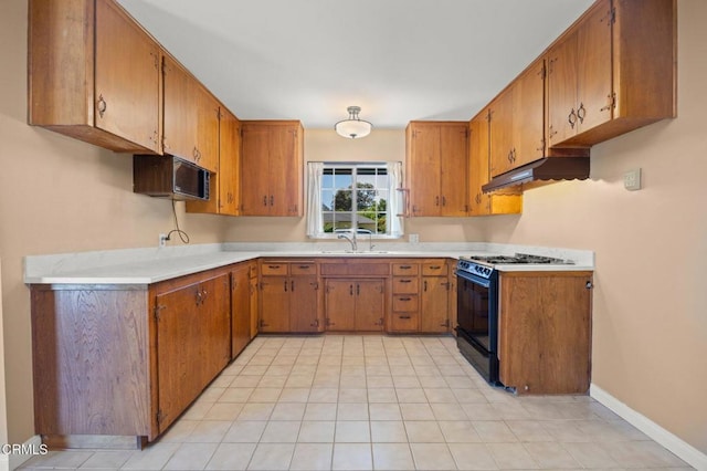 260 N Wake Forest Ave, Ventura, CA 93003 - kitchen featuring black gas stove, under cabinet range hood, and brown cabinetry