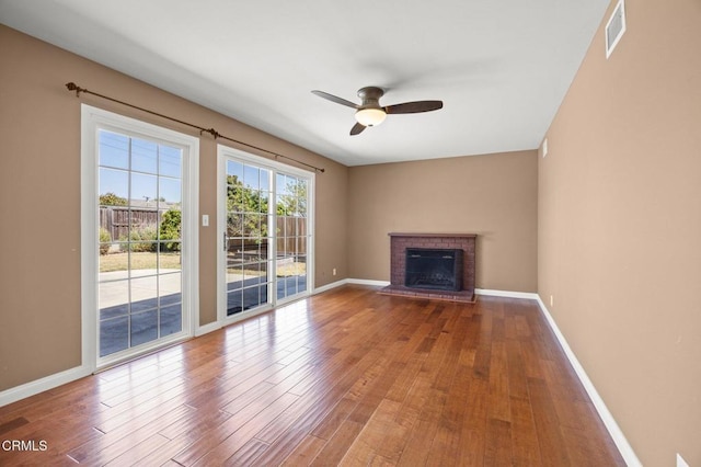 260 N Wake Forest Ave, Ventura, CA 93003 - unfurnished living room with ceiling fan, wood finished floors, baseboards, and a brick fireplace