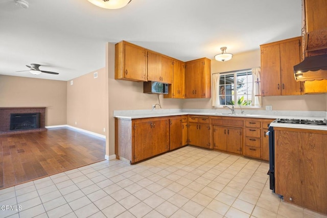 260 N Wake Forest Ave, Ventura, CA 93003 - kitchen featuring light countertops, open floor plan, a ceiling fan, brown cabinets, and gas stove
