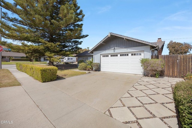 260 N Wake Forest Ave, Ventura, CA 93003 - view of side of home with concrete driveway, an attached garage, and a chimney