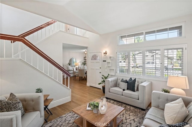 61 Bridgeport, Irvine, CA 92620 - living area with plenty of natural light, stairway, high vaulted ceiling, wood finished floors, and baseboards