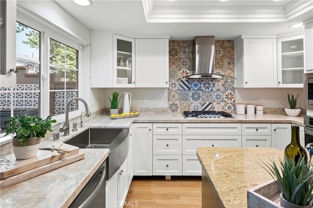 61 Bridgeport, Irvine, CA 92620 - kitchen with wall chimney range hood, stainless steel appliances, a sink, white cabinetry, and a raised ceiling