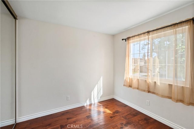 61 Bridgeport, Irvine, CA 92620 - spare room featuring baseboards and dark wood-type flooring