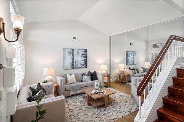 61 Bridgeport, Irvine, CA 92620 - living area with wood finished floors, stairs, vaulted ceiling, and baseboards
