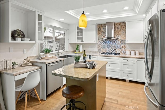 61 Bridgeport, Irvine, CA 92620 - kitchen with stainless steel appliances, wall chimney range hood, a sink, a kitchen bar, and a kitchen island