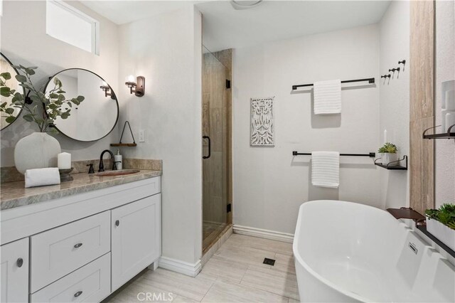 61 Bridgeport, Irvine, CA 92620 - full bathroom featuring a shower stall, baseboards, vanity, and a soaking tub
