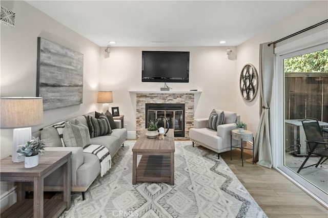 61 Bridgeport, Irvine, CA 92620 - living room featuring wood finished floors, a glass covered fireplace, and recessed lighting