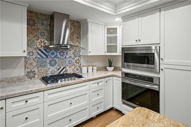 61 Bridgeport, Irvine, CA 92620 - kitchen with stainless steel appliances, wall chimney exhaust hood, white cabinetry, and glass insert cabinets