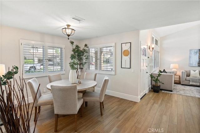 61 Bridgeport, Irvine, CA 92620 - dining room featuring baseboards, light wood-style flooring, and healthy amount of natural light