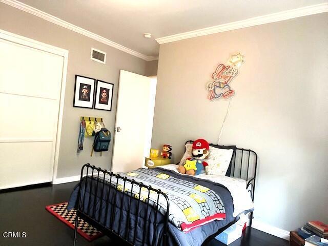 10456 Pomering Rd, Downey, CA 90241 - bedroom featuring ornamental molding, baseboards, and wood finished floors
