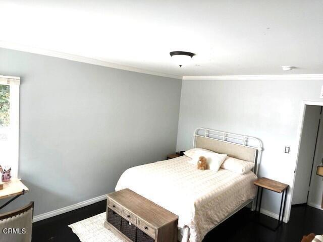 10456 Pomering Rd, Downey, CA 90241 - bedroom featuring ornamental molding, baseboards, and dark wood-type flooring